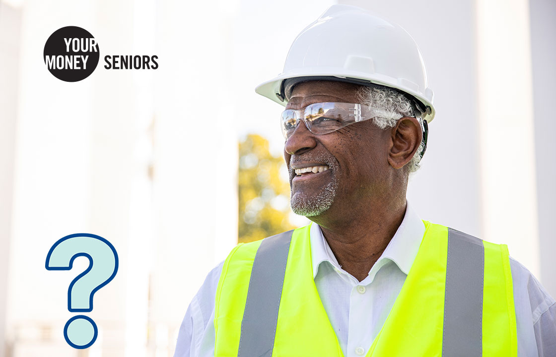 a senior man wearing safety glassses, a hard hat and a construction vest
